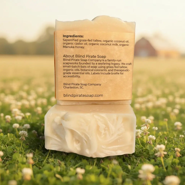 Milk & Honey back panel clearly showing ingredients and Blind Pirate Soap story, nestled among cheerful wild daisies.