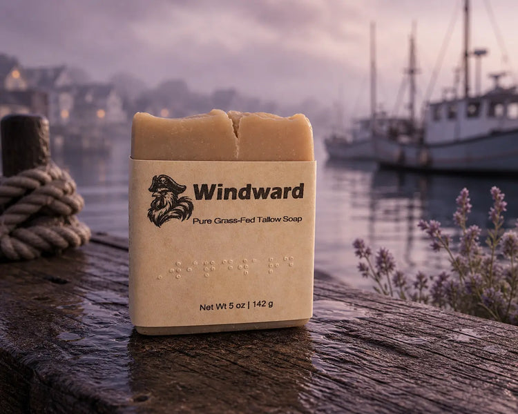 Windward tallow soap bar with label on wet dock, mooring rope, lavender, misty harbor at dusk. Blind Pirate Trading Co.