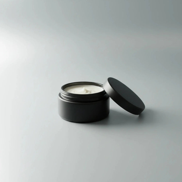 ⚓ Dead Calm — Unscented Beard Balm Blind Pirate Trading Co. An open matte black cosmetic jar filled with white cream, with its matching lid