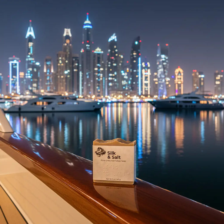 Silk & Salt — Dubai Marina Night viewed from the rail of a mega yacht on dark still waters. Skyline glittering.